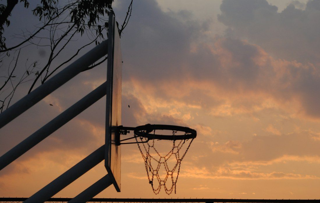 Outdoor basketball hoop at sunset in Tegucigalpa, Honduras. Illustrative photograph.